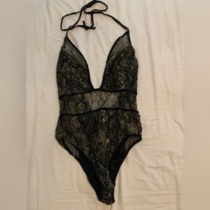 Iheartraves black and gold bodysuit